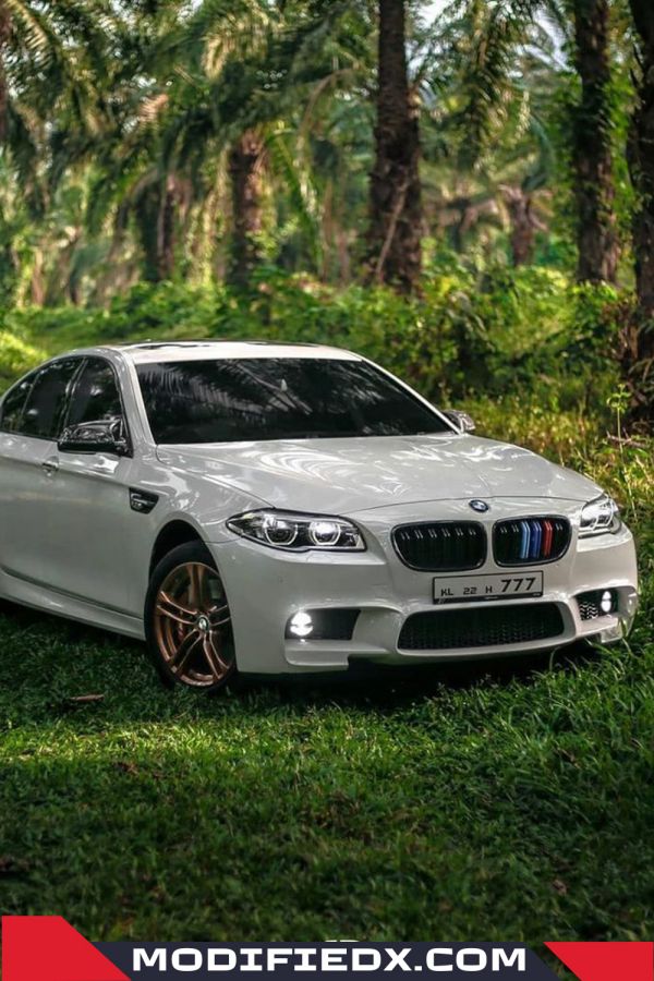 White BMW with gold alloys